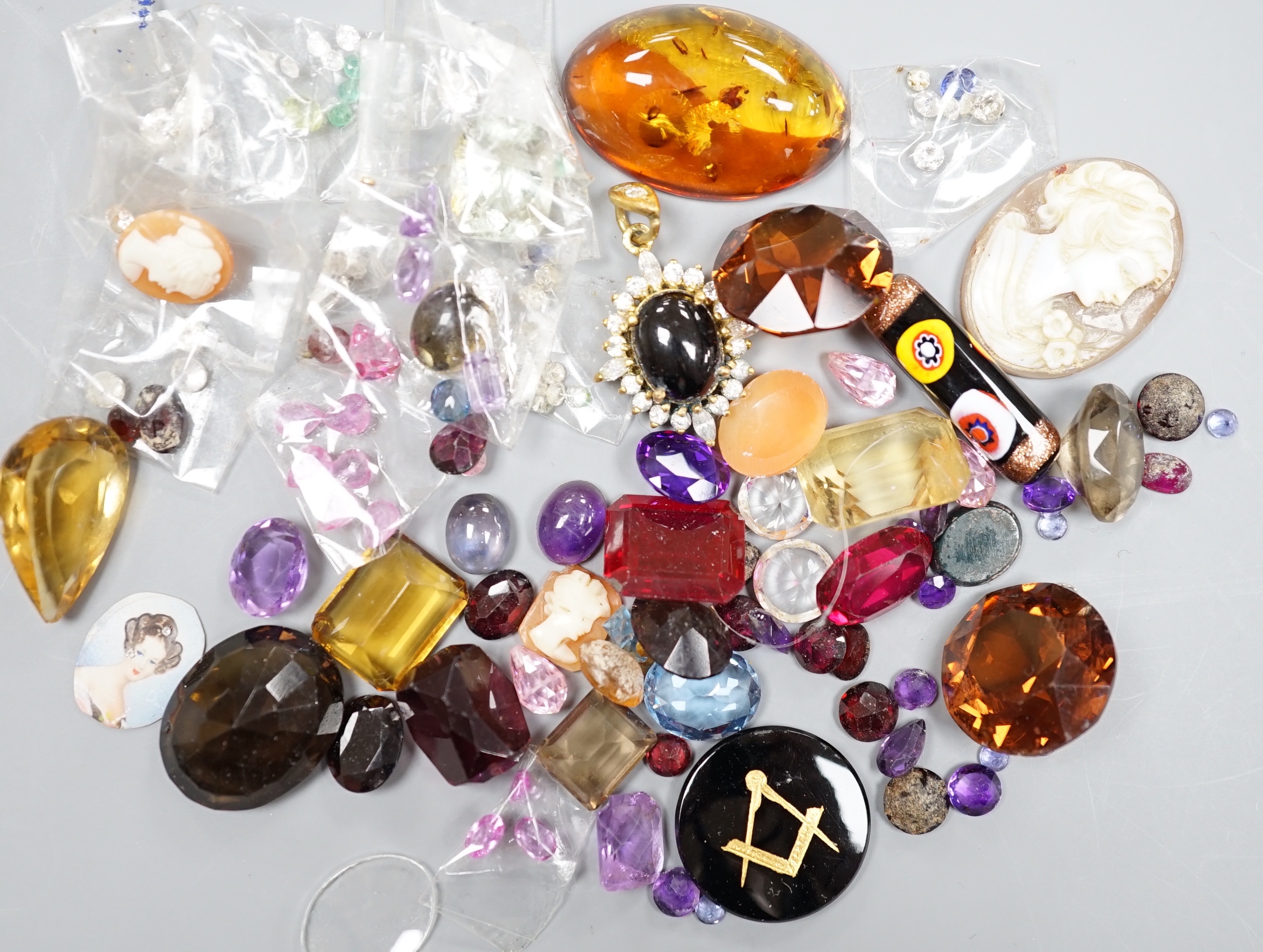 A quantity of assorted unmounted cut gemstones including small diamonds and other minor jewellery.